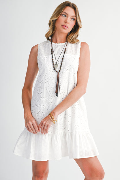 Woman wearing a white sleeveless dress with a necklace on a white background