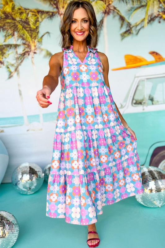 Woman wearing a floral dress in a retro setting with a vintage car and disco balls.